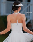 White Bow Halter Tennis Top T-back open-back design, flattering halter T-strap and Pom Pêche logo back detail, worn with Pom Pêche visor