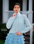 Close-up of women’s sun jacket, featuring stand-up collar, ruffled edge, and adjustable drawstring waist for a flattering fit