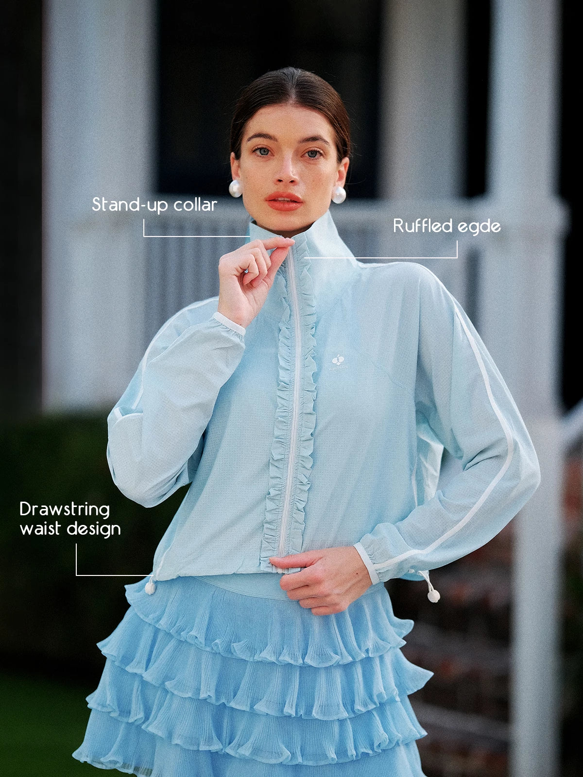 Close-up of women’s sun jacket, featuring stand-up collar, ruffled edge, and adjustable drawstring waist for a flattering fit